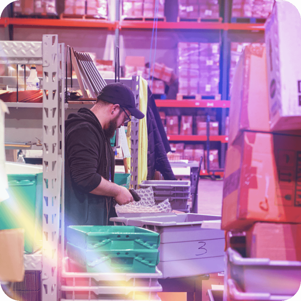 A Village Corner Store warehouse worker scans products to pack a customer order in our Village Corner Store warehouse located in Troy, Michigan.